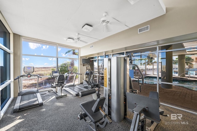 gym with plenty of natural light, a wall of windows, and visible vents
