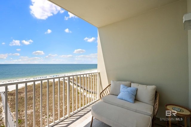 balcony with a water view and a beach view