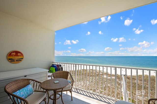 balcony with a water view and a beach view
