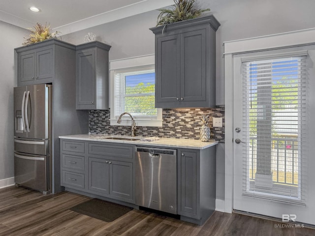 kitchen with dark wood-type flooring, sink, gray cabinets, and stainless steel appliances