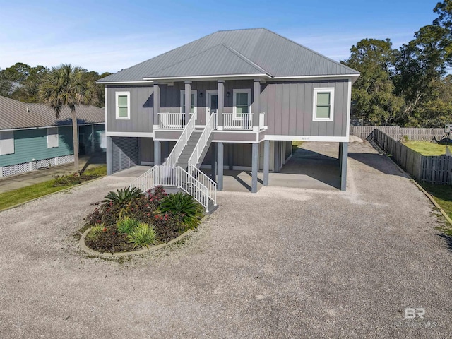 coastal inspired home with a carport and a porch