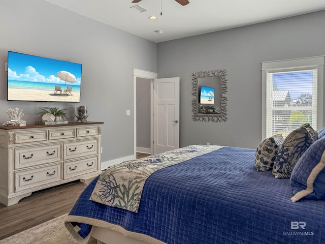 bedroom with ceiling fan and dark hardwood / wood-style floors