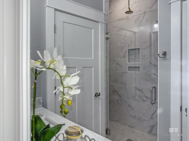 bathroom with a shower with door