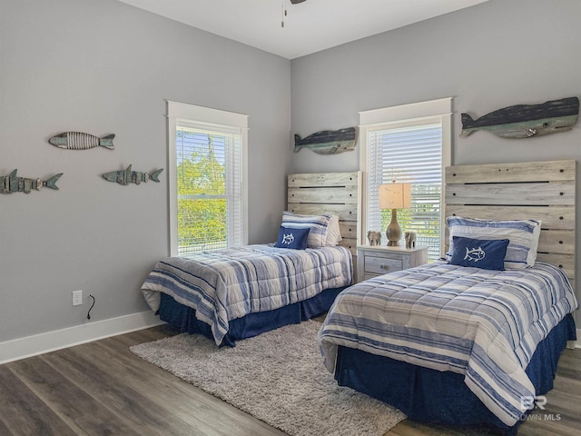 bedroom featuring dark hardwood / wood-style flooring and multiple windows