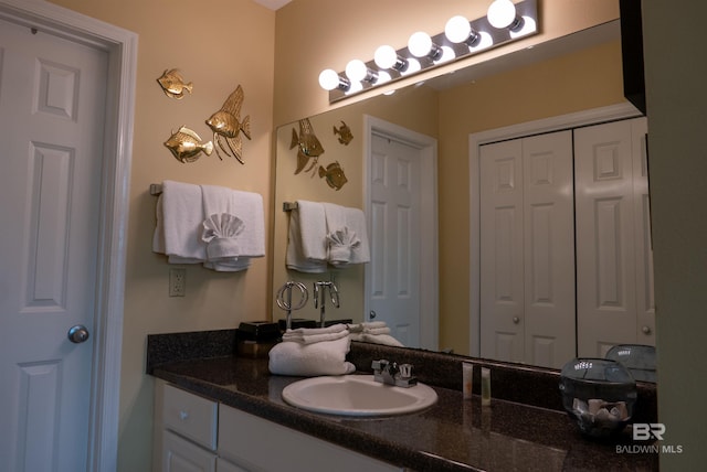 bathroom featuring vanity and a closet