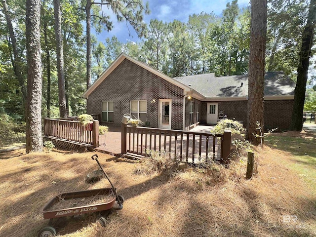 603 Northshore Dr, Bay Minette, AL 36507 - rear view of property featuring brick siding, a wooden deck, and a shingled roof