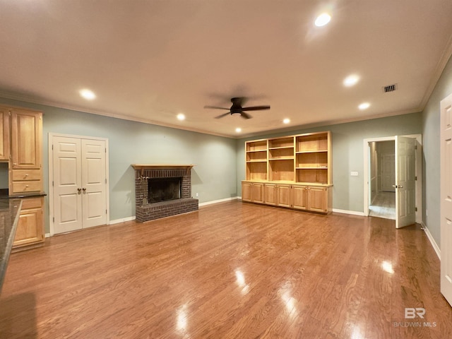 603 Northshore Dr, Bay Minette, AL 36507 - unfurnished living room with crown molding, ceiling fan, recessed lighting, wood finished floors, and a fireplace