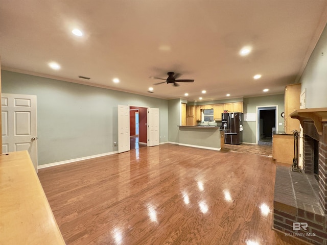 603 Northshore Dr, Bay Minette, AL 36507 - unfurnished living room featuring a brick fireplace, recessed lighting, a ceiling fan, ornamental molding, and baseboards