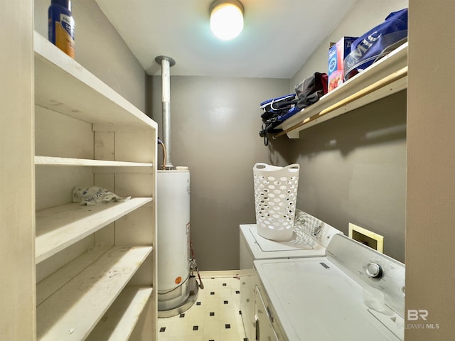603 Northshore Dr, Bay Minette, AL 36507 - clothes washing area featuring washing machine and dryer, gas water heater, and tile patterned floors