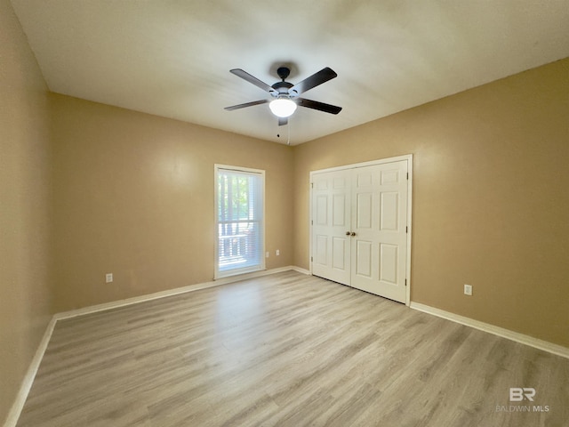 603 Northshore Dr, Bay Minette, AL 36507 - unfurnished bedroom featuring light wood finished floors, baseboards, a closet, and ceiling fan