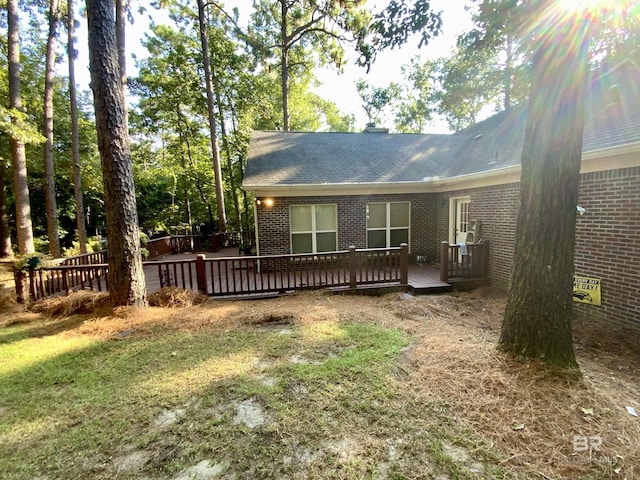 603 Northshore Dr, Bay Minette, AL 36507 - rear view of property featuring brick siding, a wooden deck, and a shingled roof
