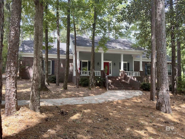 603 Northshore Dr, Bay Minette, AL 36507 - view of front of property featuring covered porch, brick siding, and stairway