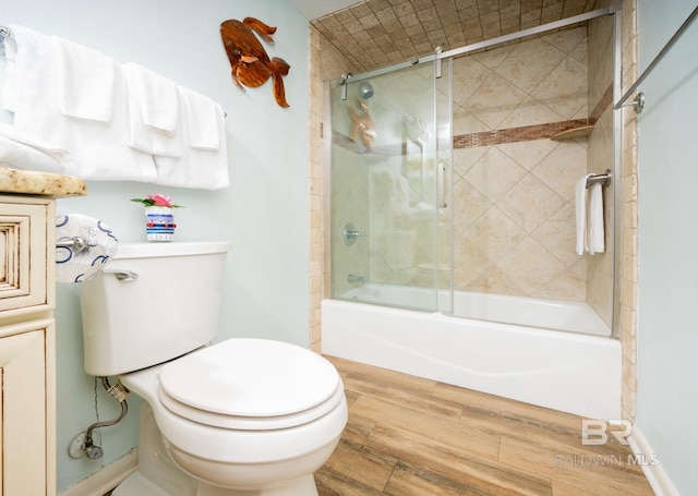 24132 Perdido Beach Blvd Unit 1024, Orange Beach, AL 36561 - full bathroom featuring combined bath / shower with glass door, toilet, baseboards, and wood finished floors