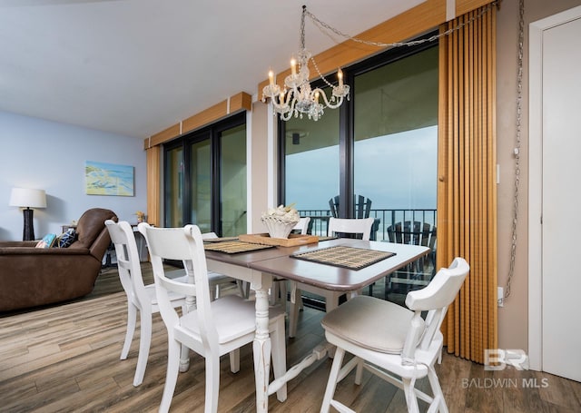 24132 Perdido Beach Blvd Unit 1024, Orange Beach, AL 36561 - dining space featuring an inviting chandelier and wood finished floors