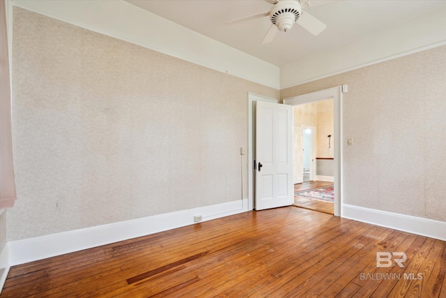 spare room with hardwood / wood-style floors and ceiling fan