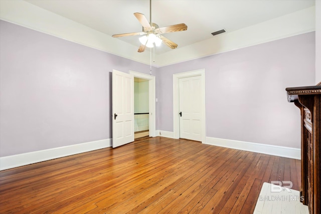 unfurnished living room featuring wood-type flooring and ceiling fan