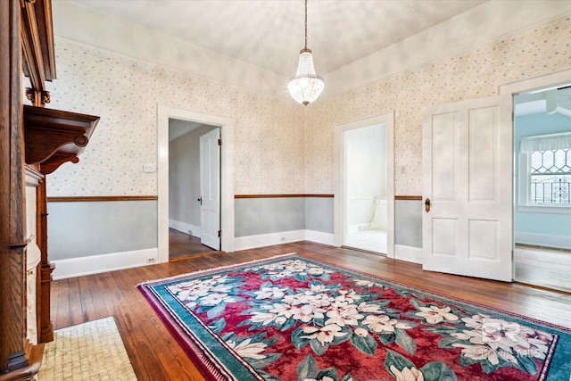 interior space featuring dark wood-type flooring and an inviting chandelier