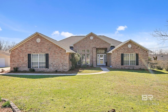 view of front of home featuring brick siding and a front yard