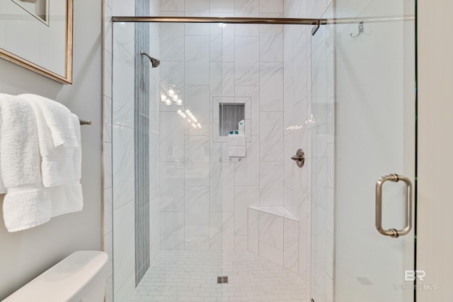 full bath with a stall shower and toilet