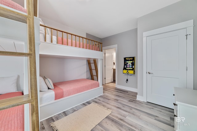 bedroom featuring baseboards and wood finished floors