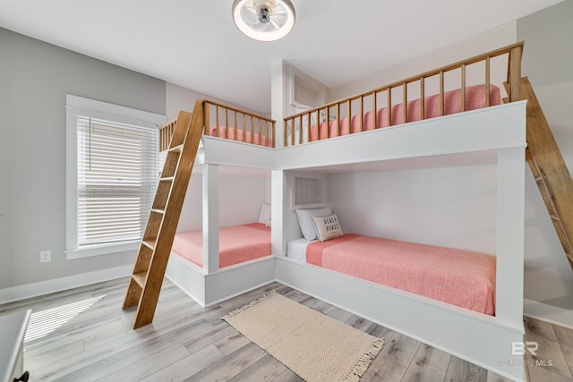 bedroom featuring baseboards and wood finished floors