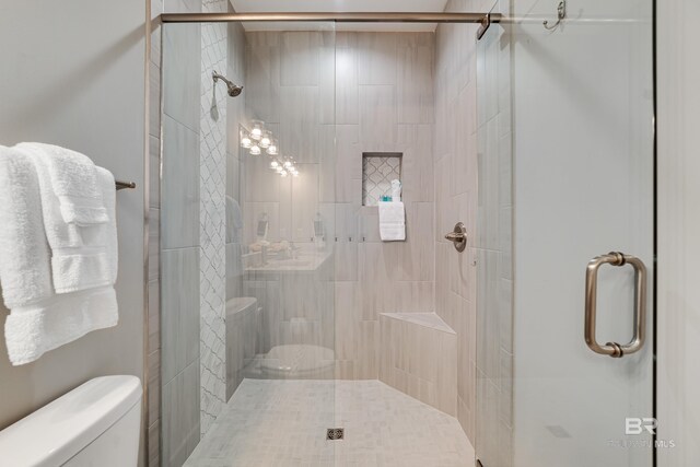 bathroom featuring a shower stall and toilet