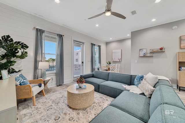 living area with a ceiling fan, recessed lighting, visible vents, and wood finished floors