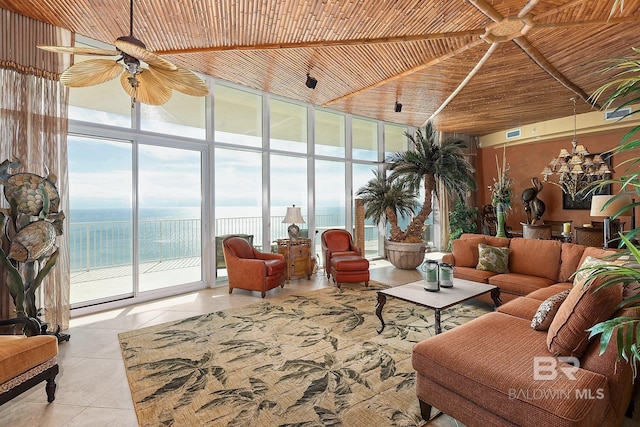 interior space with ceiling fan, a water view, and wooden ceiling