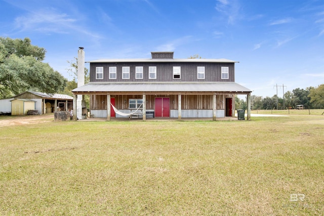 country-style home featuring an outbuilding, an exterior structure, and a garage