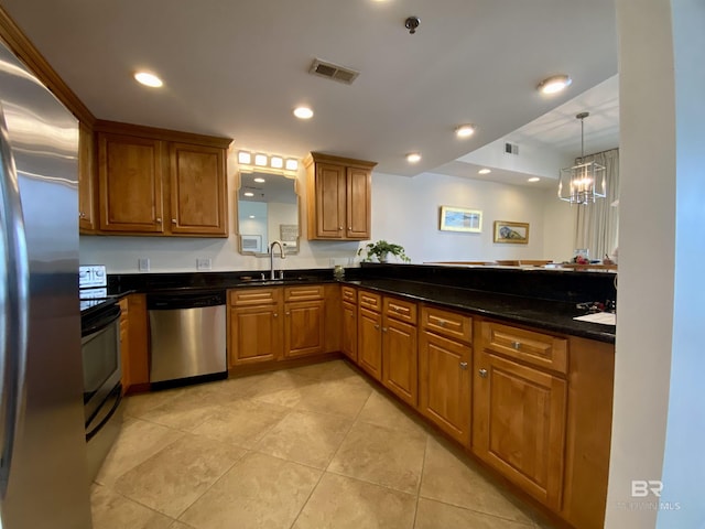 kitchen featuring visible vents, brown cabinets, stainless steel appliances, a sink, and recessed lighting