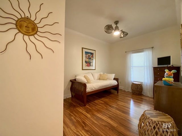 living area featuring baseboards and wood finished floors