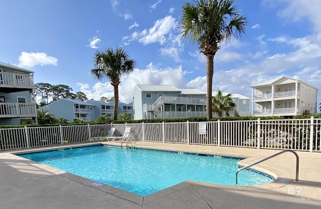 community pool featuring a residential view and fence