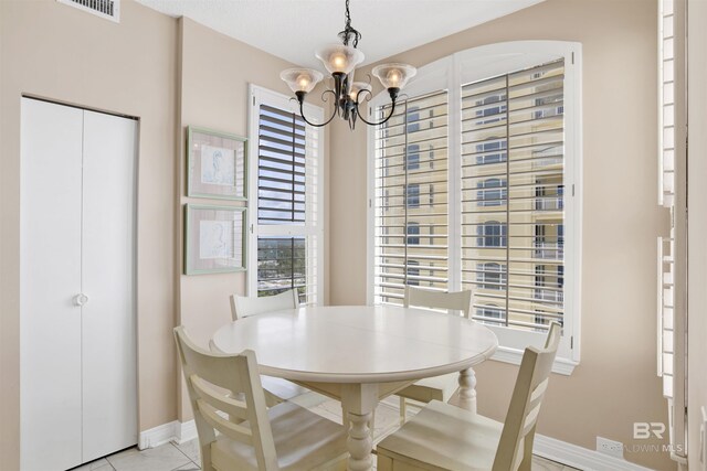 13601 Perdido Key Dr Unit W-12A, Perdido Key, FL 32507 - dining room featuring plenty of natural light, visible vents, baseboards, and an inviting chandelier