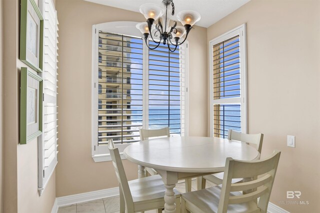 13601 Perdido Key Dr Unit W-12A, Perdido Key, FL 32507 - dining room with baseboards and a notable chandelier