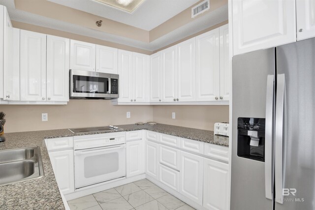 13601 Perdido Key Dr Unit W-12A, Perdido Key, FL 32507 - kitchen with a sink, marble finish floor, stainless steel appliances, white cabinetry, and visible vents