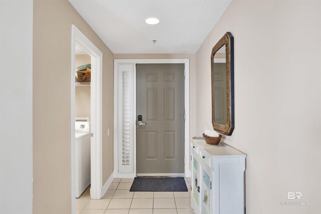 13601 Perdido Key Dr Unit W-12A, Perdido Key, FL 32507 - entrance foyer featuring baseboards, washer / clothes dryer, and light tile patterned floors