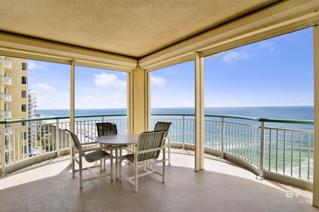 13601 Perdido Key Dr Unit W-12A, Perdido Key, FL 32507 - sunroom featuring a textured ceiling, a view of the beach, a water view, and a healthy amount of sunlight
