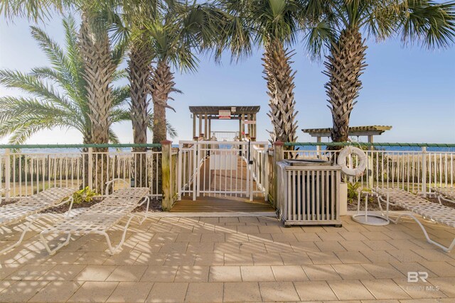 13601 Perdido Key Dr Unit W-12A, Perdido Key, FL 32507 - view of patio featuring fence, a pergola, a water view, and a playground