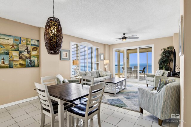 13601 Perdido Key Dr Unit W-12A, Perdido Key, FL 32507 - dining area featuring ceiling fan, baseboards, light tile patterned flooring, and a textured ceiling