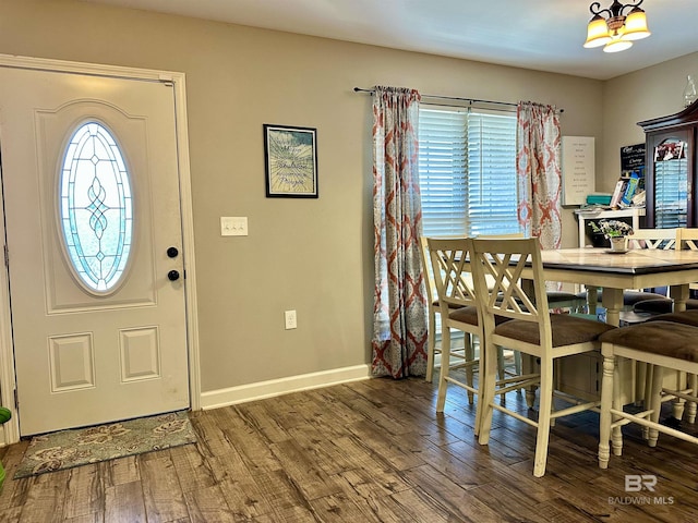 entrance foyer featuring hardwood / wood-style flooring and a notable chandelier