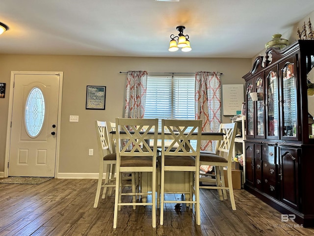 dining space with dark hardwood / wood-style flooring