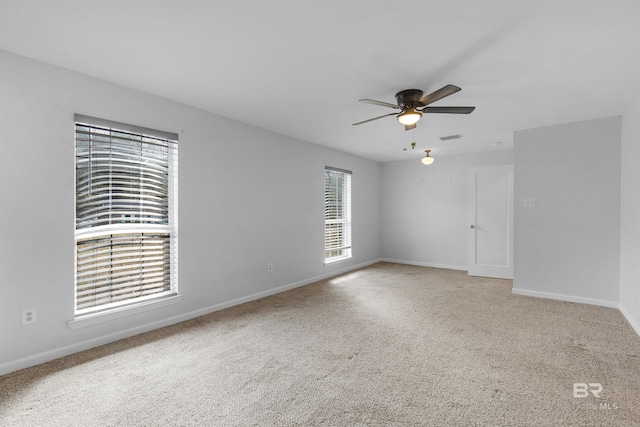 unfurnished room featuring ceiling fan and carpet flooring