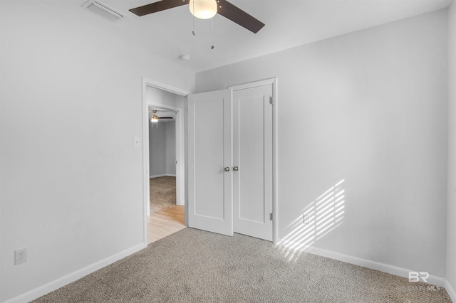 interior space with ceiling fan and light carpet