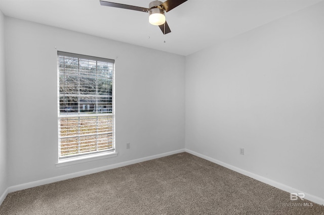 carpeted empty room featuring a wealth of natural light and ceiling fan