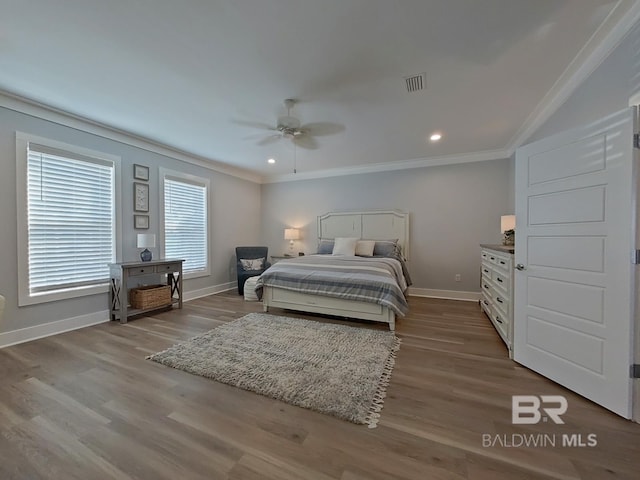 bedroom with crown molding, ceiling fan, and light hardwood / wood-style flooring