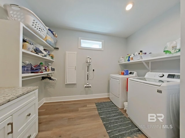 washroom featuring light hardwood / wood-style flooring and washer and clothes dryer