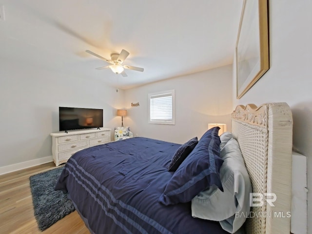 bedroom with light hardwood / wood-style flooring and ceiling fan