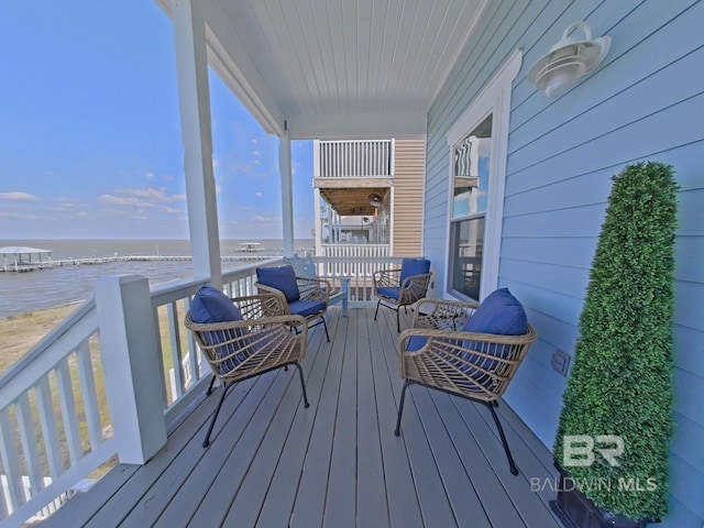 wooden terrace featuring a water view