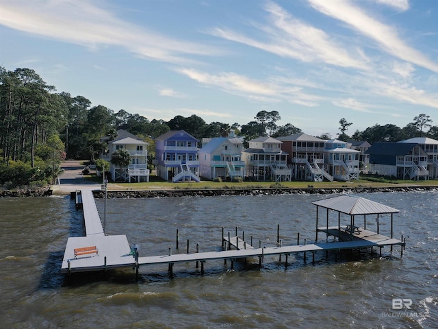 view of dock featuring a water view and a residential view