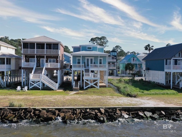 rear view of property with a residential view and stairs